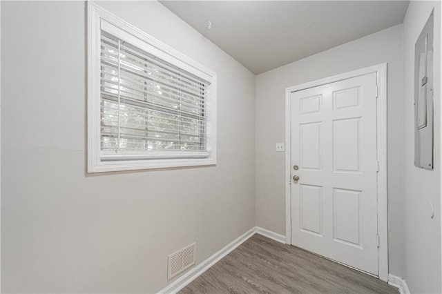 doorway featuring wood finished floors, baseboards, and visible vents
