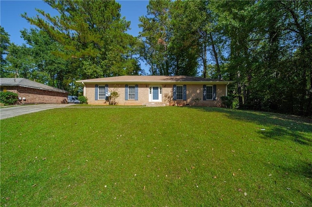 single story home featuring a front lawn and concrete driveway