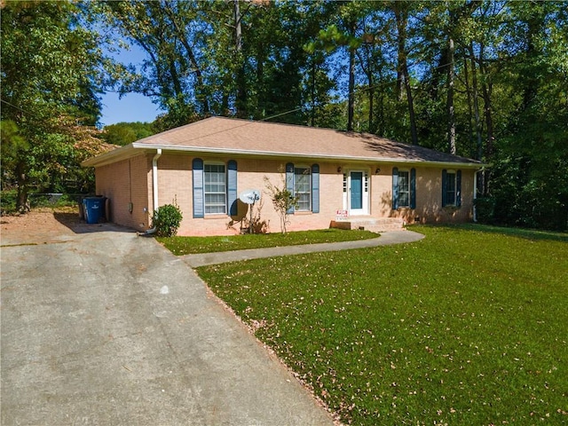 single story home featuring brick siding, driveway, and a front lawn