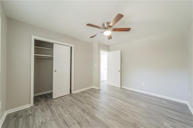 unfurnished bedroom with a closet, baseboards, a ceiling fan, and light wood-style floors