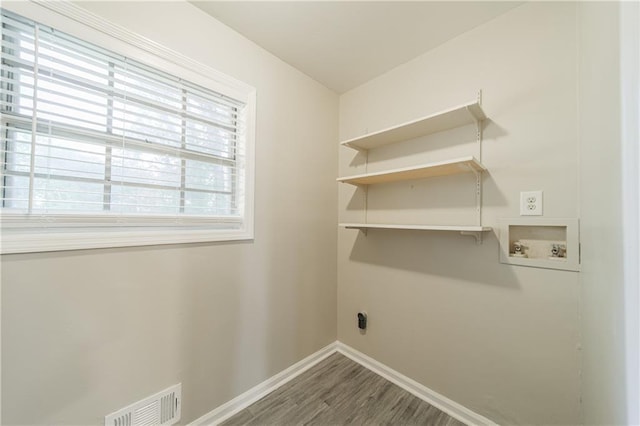 washroom with baseboards, visible vents, laundry area, hookup for a washing machine, and wood finished floors