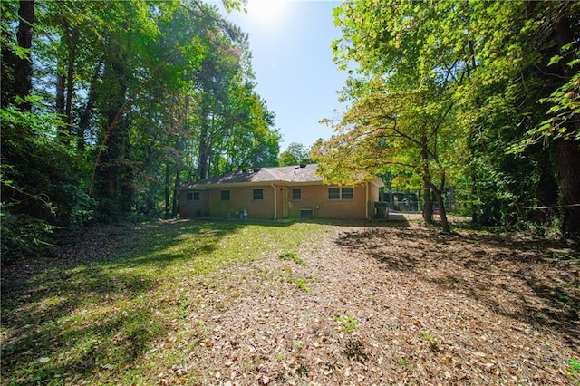 rear view of house with a yard and fence