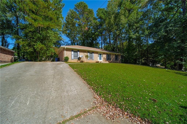 single story home with driveway and a front yard