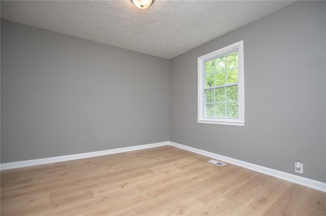 8211 Thompson St, Douglasville, GA 30134 - empty room with visible vents, baseboards, light wood-type flooring, and a textured ceiling