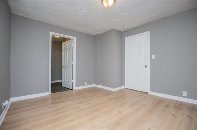 8211 Thompson St, Douglasville, GA 30134 - unfurnished room featuring light wood-style flooring, a textured ceiling, and baseboards