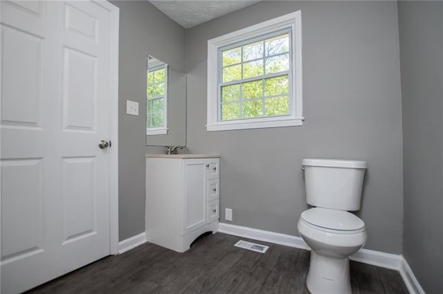 8211 Thompson St, Douglasville, GA 30134 - half bathroom with visible vents, baseboards, toilet, and wood finished floors