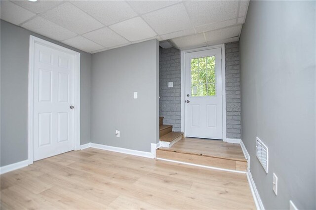 8211 Thompson St, Douglasville, GA 30134 - foyer featuring a paneled ceiling, light wood-type flooring, visible vents, stairs, and baseboards