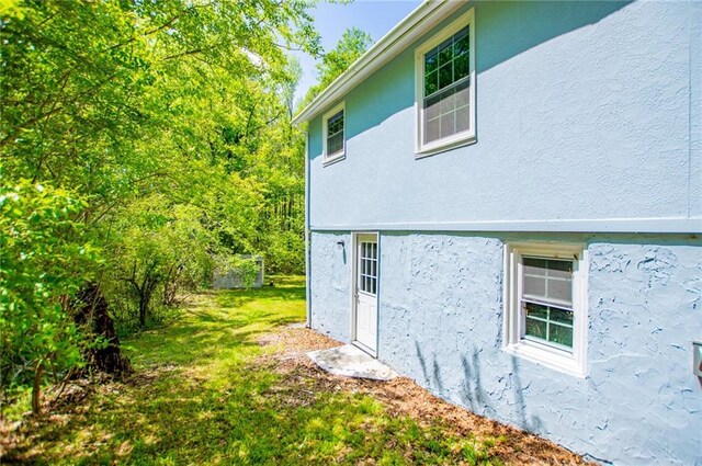 8211 Thompson St, Douglasville, GA 30134 - view of property exterior with a yard and stucco siding