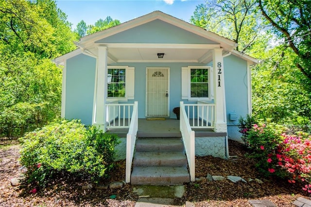 8211 Thompson St, Douglasville, GA 30134 - view of front facade with a porch and stucco siding