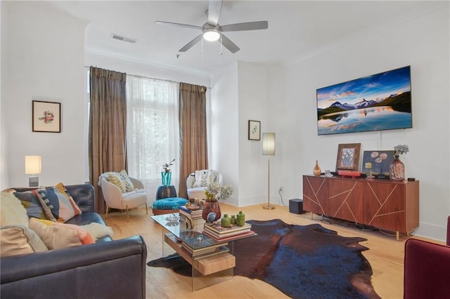 living room with hardwood / wood-style flooring and ceiling fan