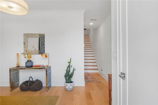 hall featuring hardwood / wood-style flooring and ornamental molding