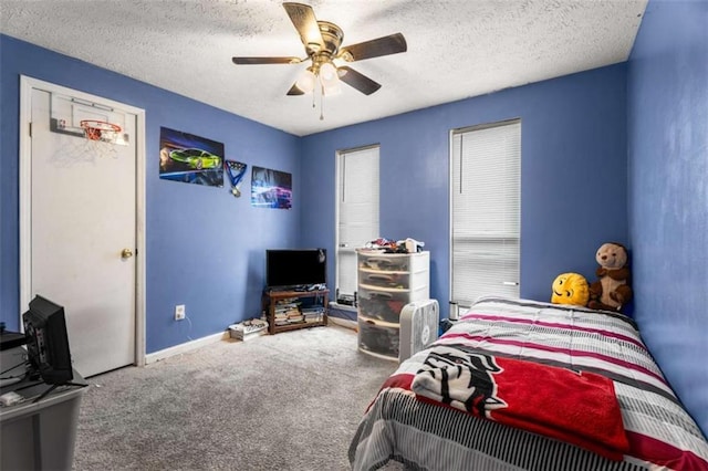 carpeted bedroom with baseboards, a textured ceiling, and a ceiling fan