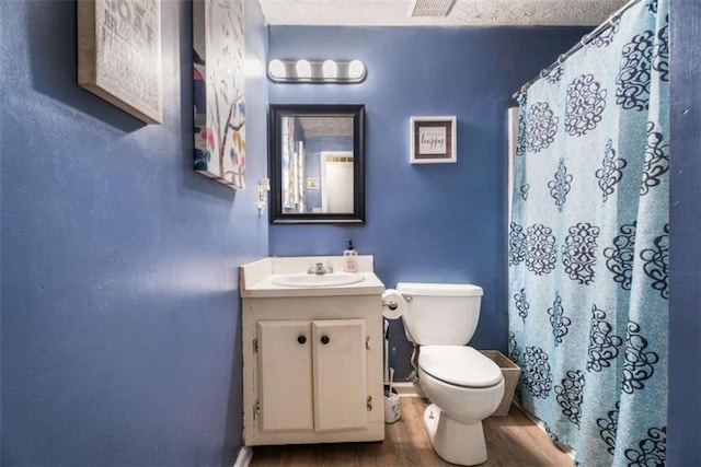 bathroom with visible vents, toilet, wood finished floors, a shower with shower curtain, and vanity