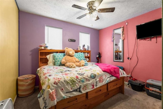 bedroom with a textured ceiling, a ceiling fan, and carpet floors