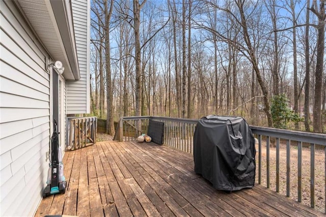 wooden deck featuring a grill