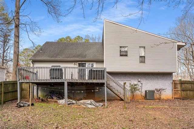 rear view of house with stairway, cooling unit, fence, and a wooden deck