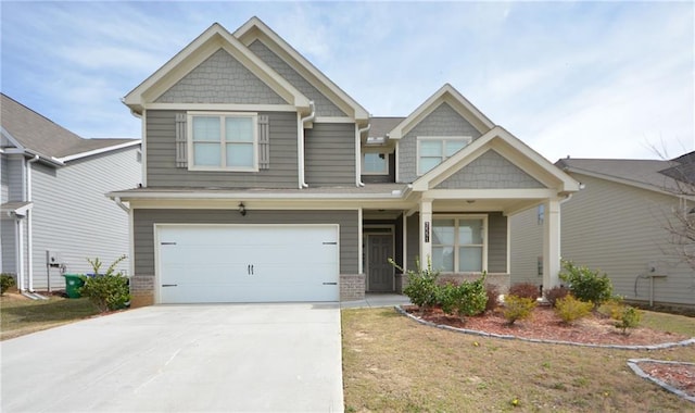 craftsman inspired home with an attached garage, brick siding, and driveway