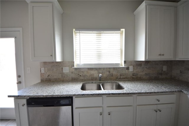 kitchen with a sink, backsplash, dishwasher, and white cabinetry