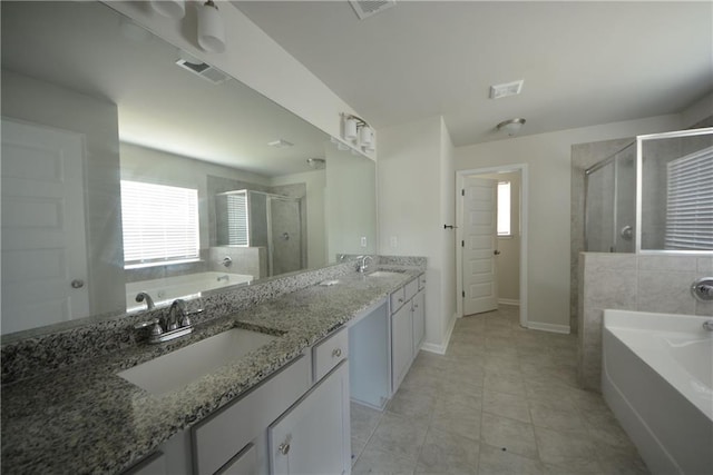 full bath with a sink, visible vents, and a wealth of natural light