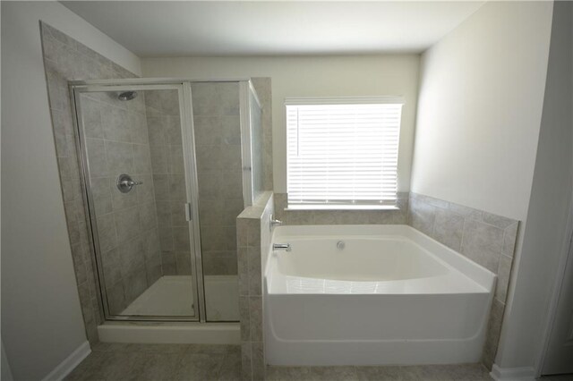 bathroom featuring a garden tub and a stall shower