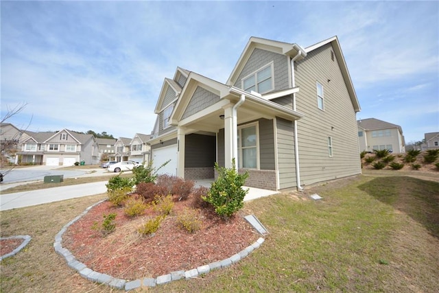 view of front of house with brick siding, a front lawn, a residential view, concrete driveway, and an attached garage