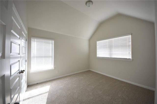 bonus room with baseboards, lofted ceiling, and carpet