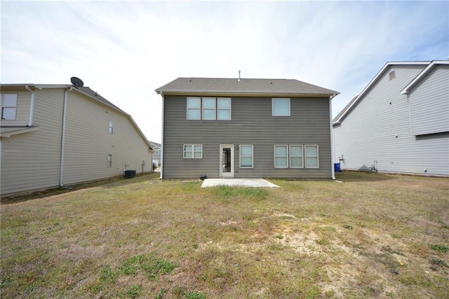 back of house with a patio and a yard