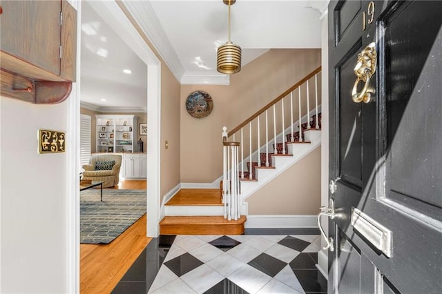 entryway with baseboards, stairway, crown molding, and recessed lighting