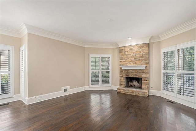 unfurnished living room with a wealth of natural light, wood finished floors, and visible vents