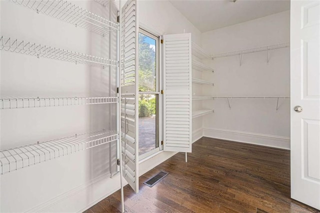 spacious closet with visible vents and wood finished floors