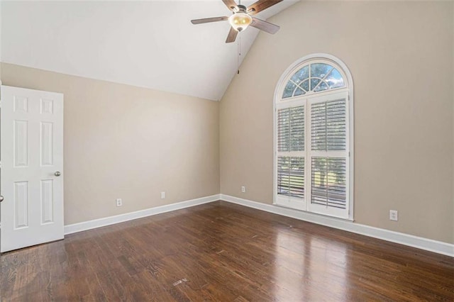 empty room with a ceiling fan, lofted ceiling, baseboards, and wood finished floors