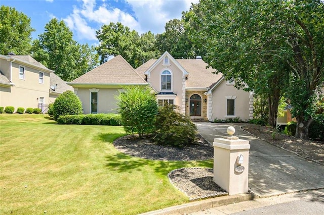 view of front of house with a front lawn and stucco siding