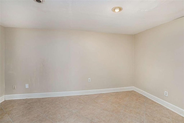 unfurnished room featuring baseboards