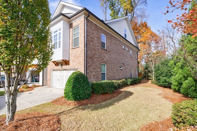 view of property exterior with a lawn and a garage