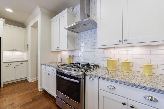 kitchen with gas range, wall chimney range hood, tasteful backsplash, dark hardwood / wood-style floors, and white cabinets