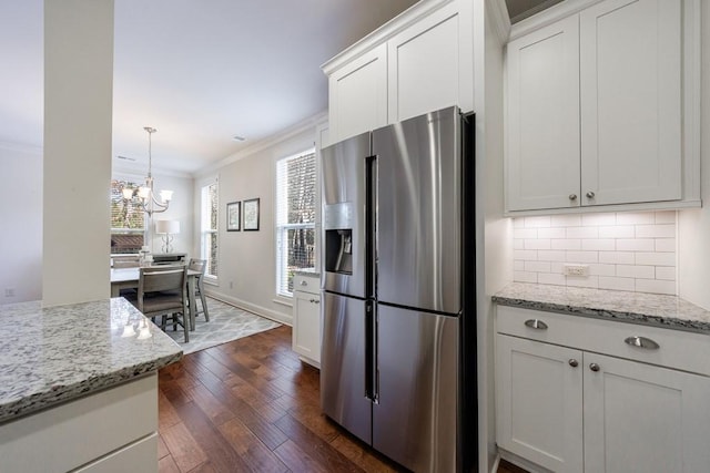 kitchen featuring white cabinetry, light stone countertops, stainless steel fridge with ice dispenser, dark hardwood / wood-style flooring, and crown molding