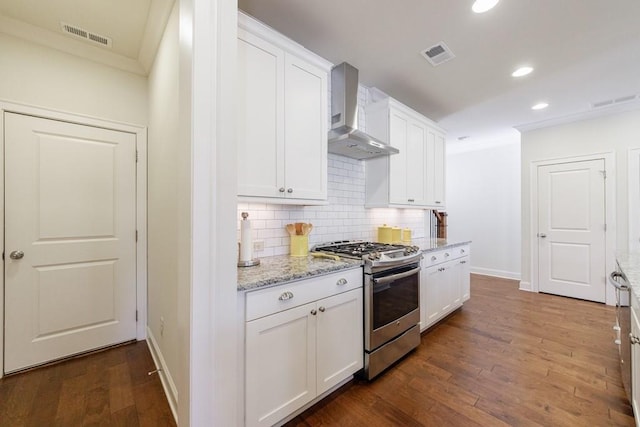 kitchen with white cabinetry, dark hardwood / wood-style floors, wall chimney range hood, and stainless steel gas range