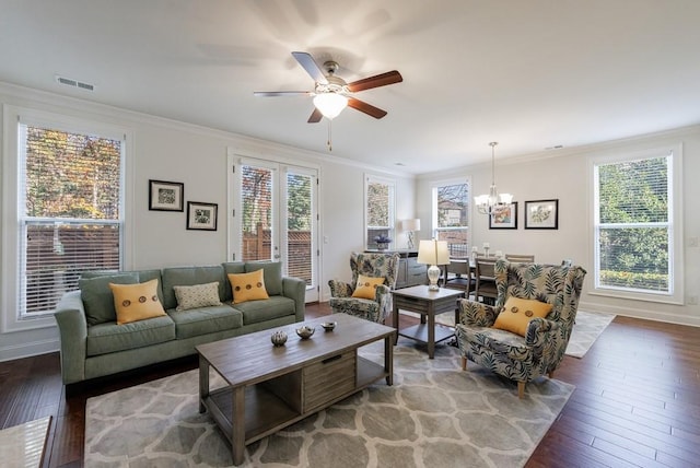 living room featuring ceiling fan with notable chandelier, wood-type flooring, and ornamental molding