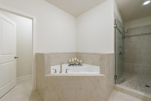 bathroom featuring tile patterned floors and separate shower and tub