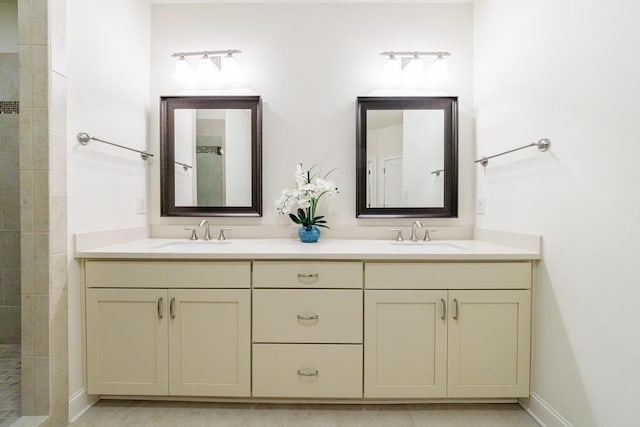 bathroom with vanity and tiled shower