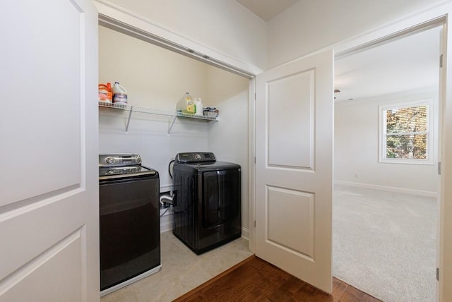 laundry area with washer and dryer and hardwood / wood-style flooring