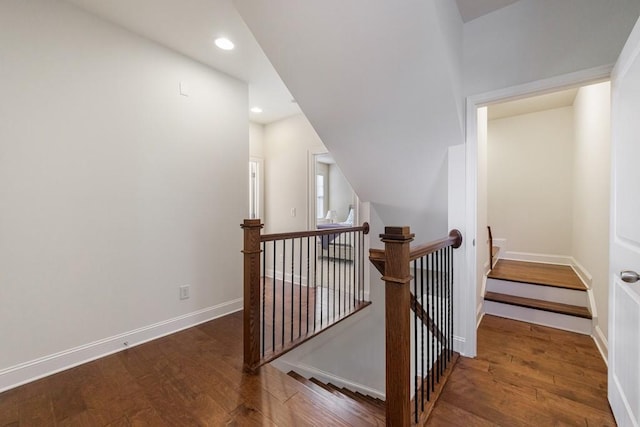 stairs featuring wood-type flooring