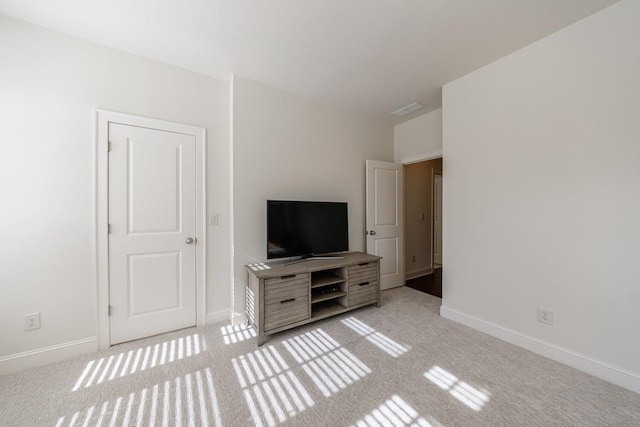 unfurnished living room featuring light colored carpet