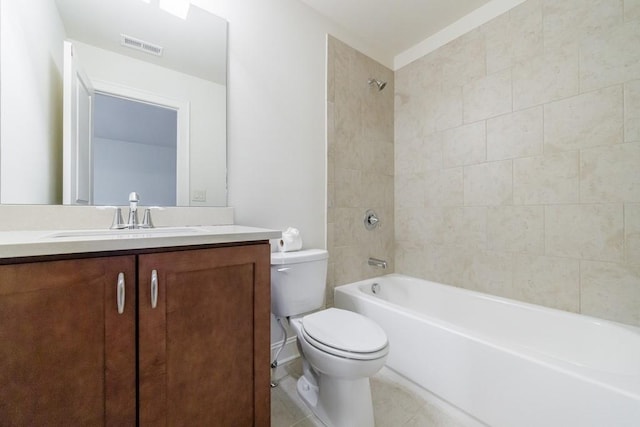 full bathroom featuring tile patterned flooring, tiled shower / bath combo, toilet, and vanity