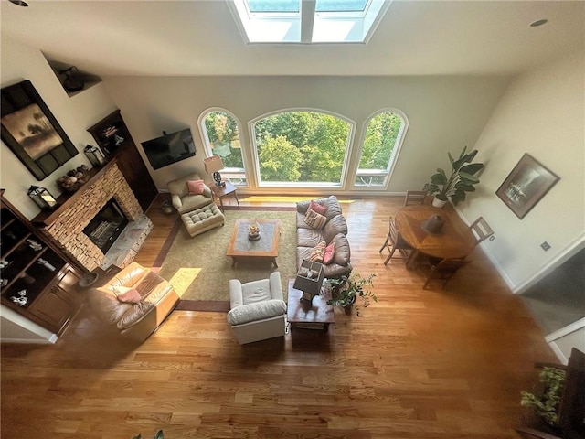 living room with wood-type flooring and a skylight