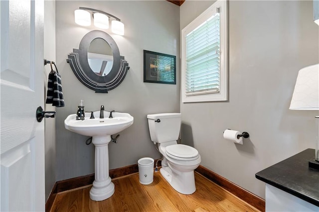 bathroom featuring toilet and wood-type flooring