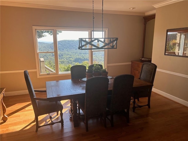 dining room featuring crown molding and hardwood / wood-style floors