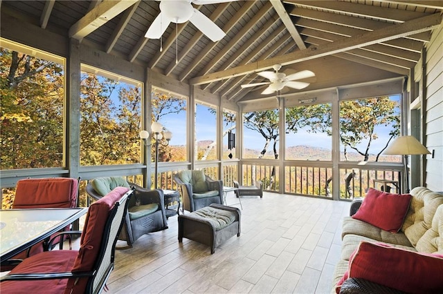 sunroom with ceiling fan, vaulted ceiling with beams, and wood ceiling