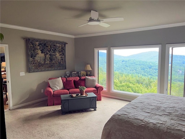 bedroom with ceiling fan, multiple windows, crown molding, and light carpet