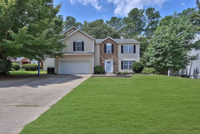 view of front of house with a front yard and a garage